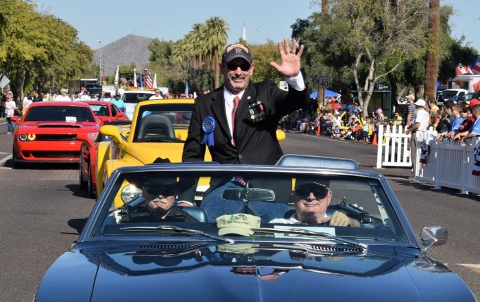 Chris Oshana rides in vehicle during Phoenix Veterans Day Parade